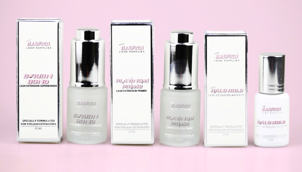 Set of lash primer and bonder products with visible brand name on a pink background